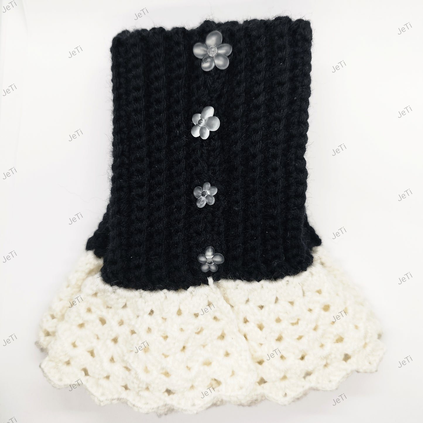Black and white crochet wrist cuffs worn on hand, elegant handmade lace accessory for women