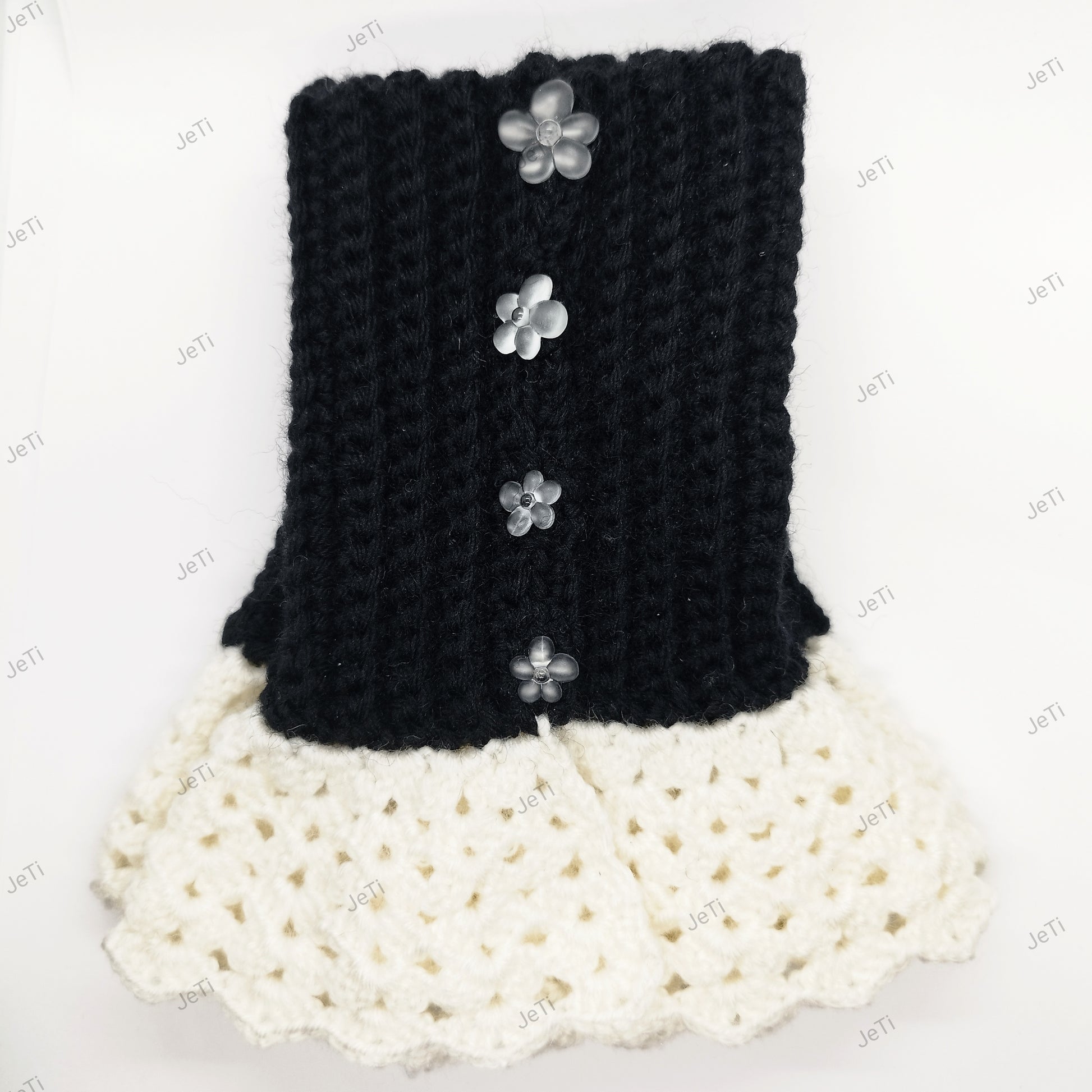 Black and white crochet wrist cuffs worn on hand, elegant handmade lace accessory for women