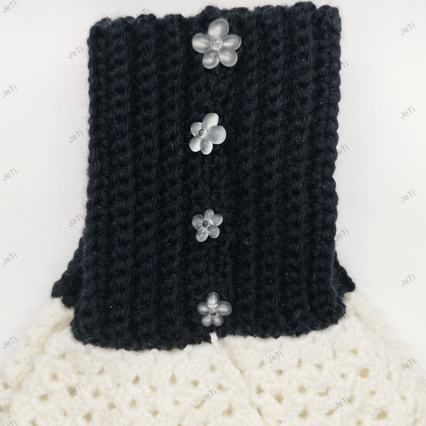 Handmade black and white crochet wrist cuffs from side view, soft lace design accessory