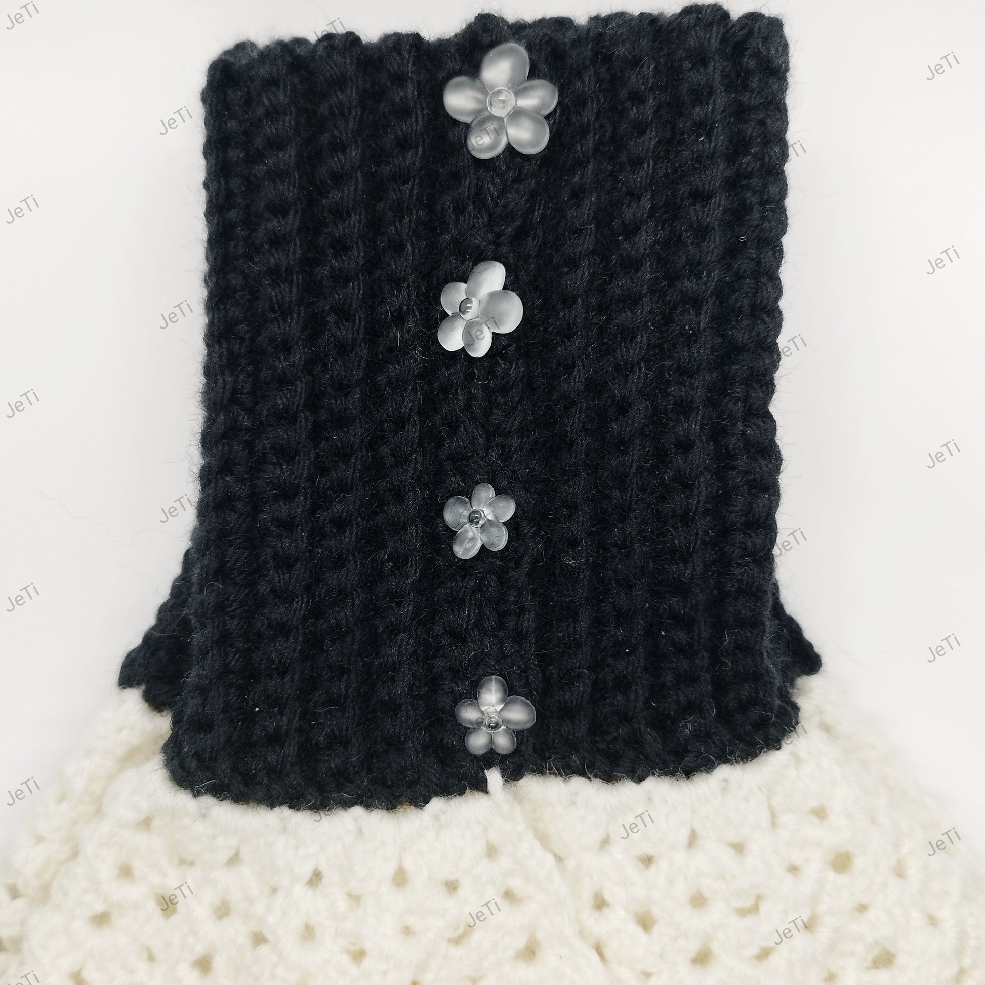 Handmade black and white crochet wrist cuffs from side view, soft lace design accessory