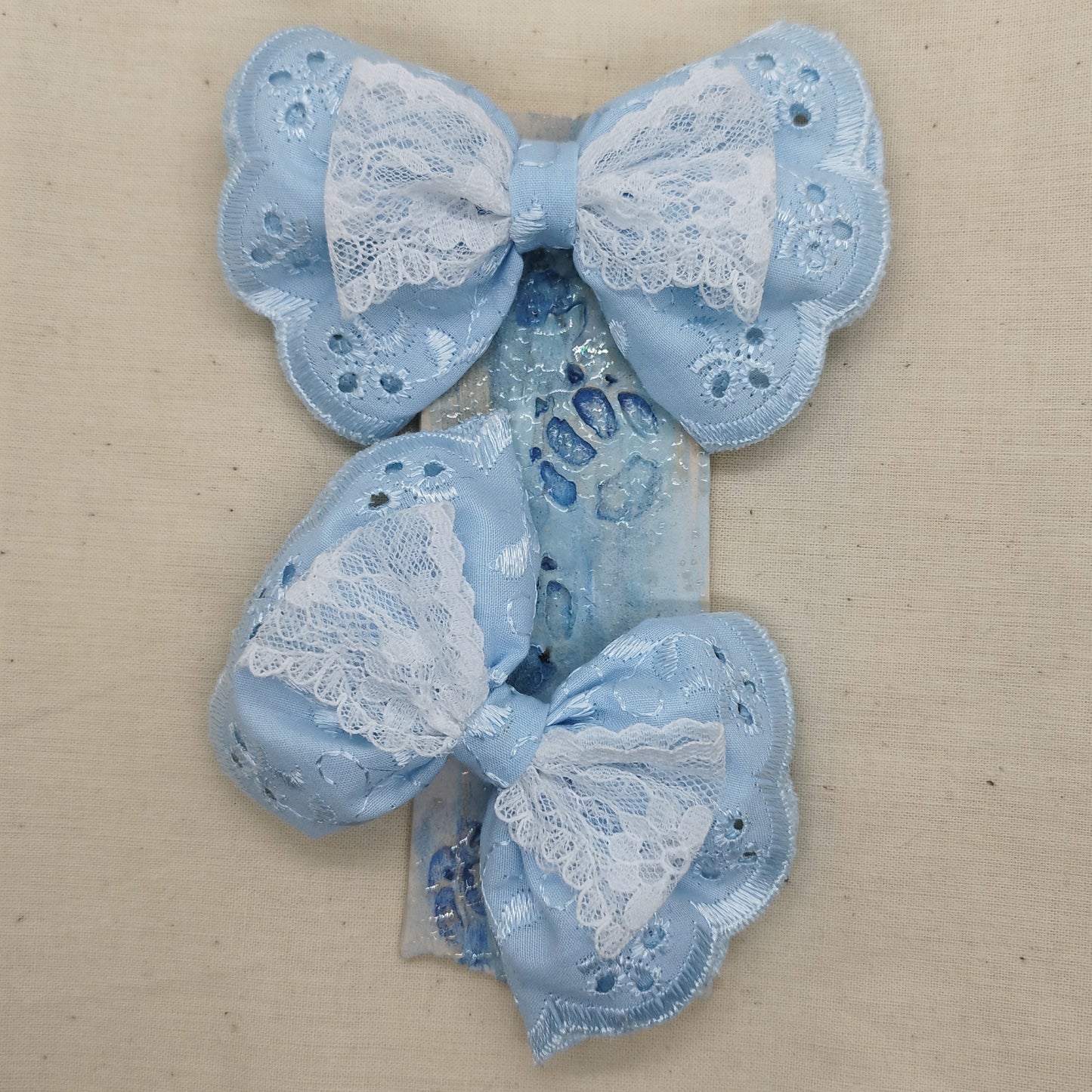 Set of handmade blue lace hair bows with floral pattern