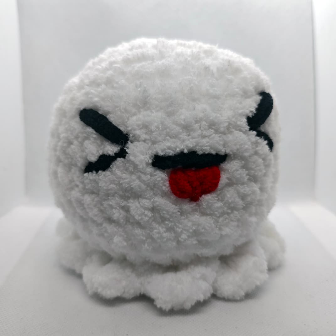 Soft white amigurumi ghost plush toy sitting upright on white background
