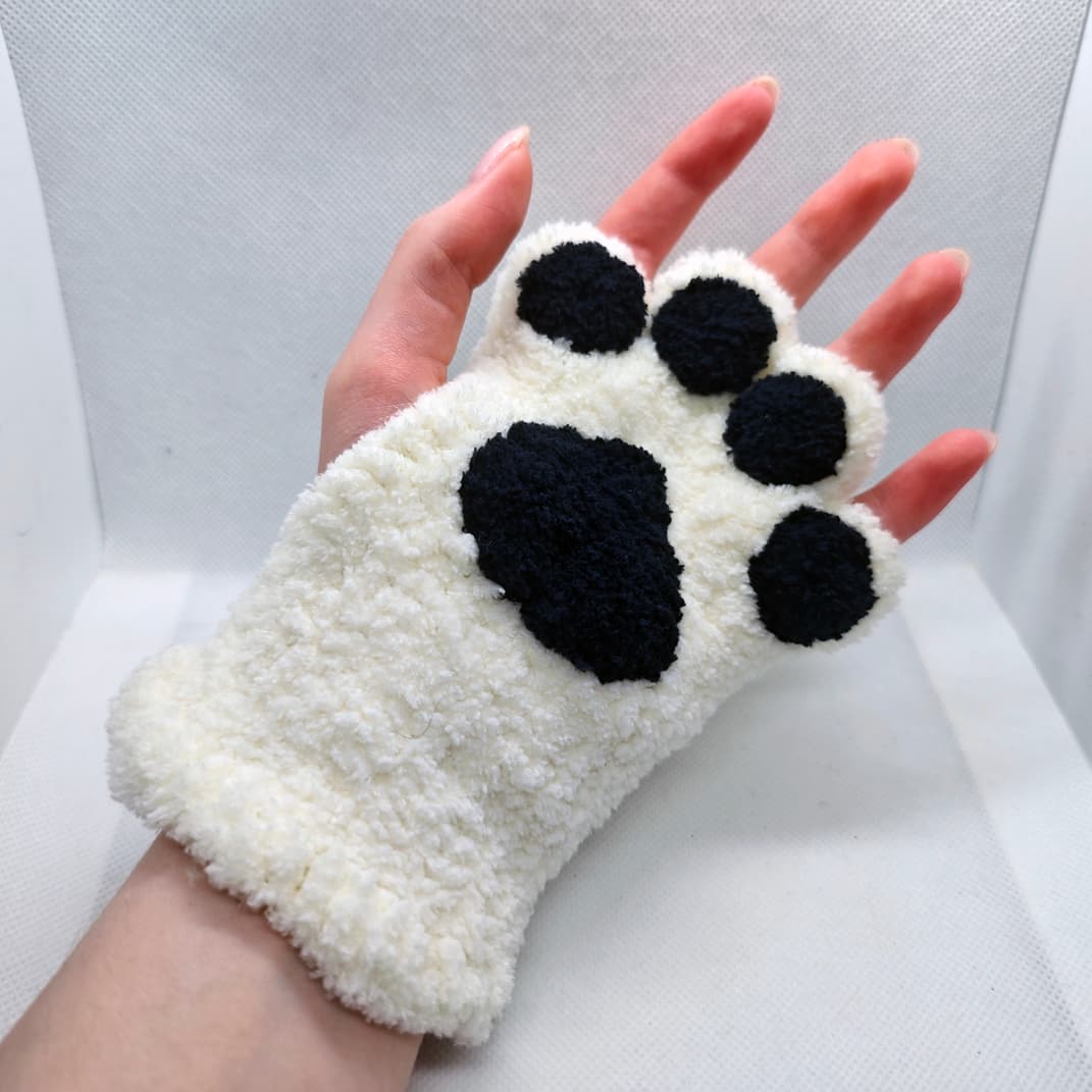 Hand wearing paw fingerless gloves showing soft fluffy texture