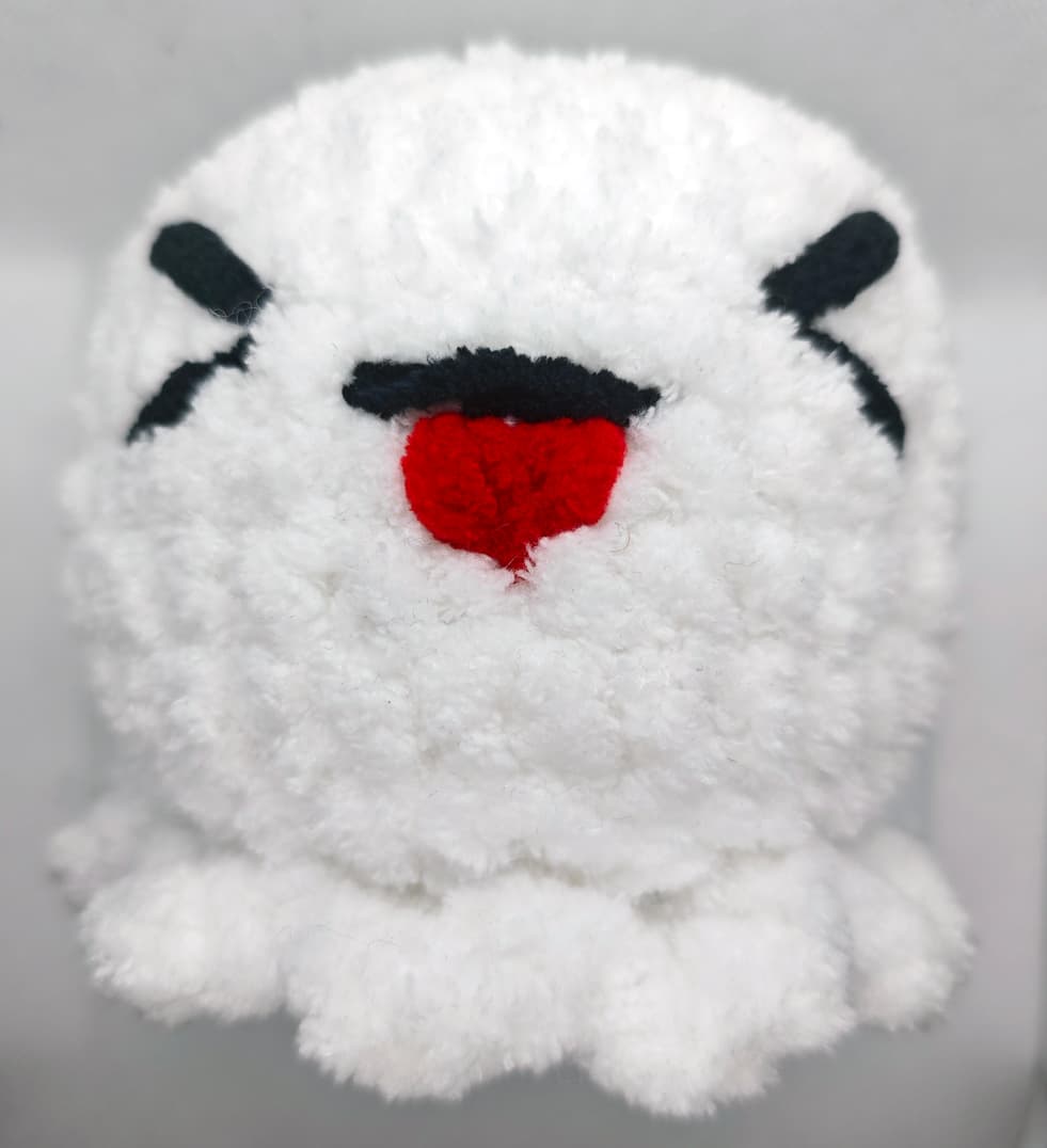 Handmade crochet ghost plush Squishy Boo with cute face close-up