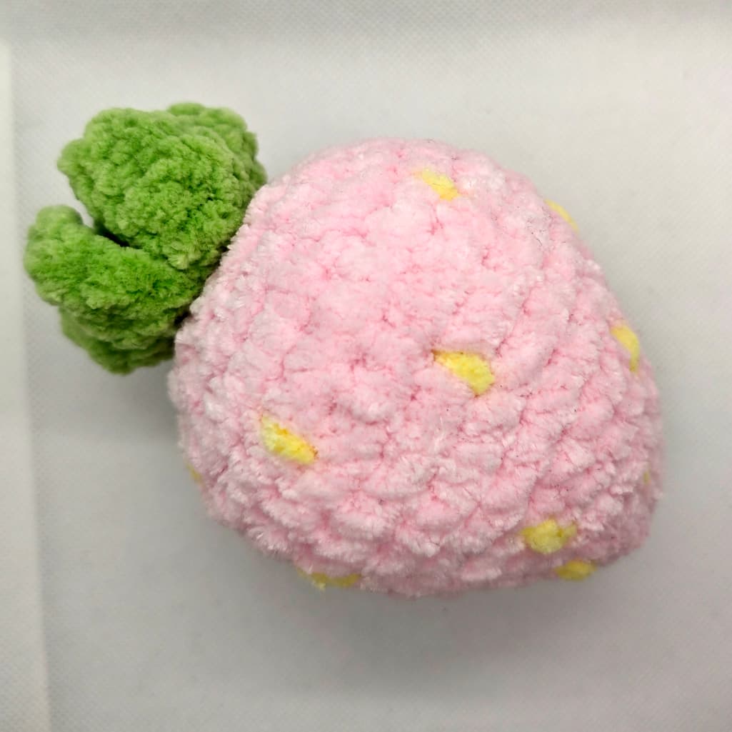 Light pink crochet strawberry fidget toy handmade close-up